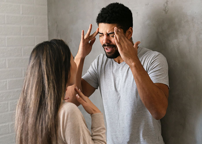 Young couple in a tense argument indoors, highlighting conflict after mom interferes in daughter&rsquo;s happy relationship.