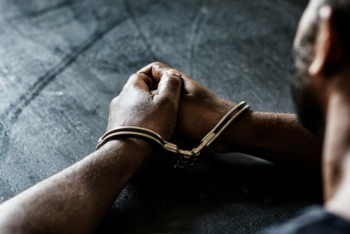 Person with hands cuffed, highlighting the moment their gut instinct was 100 percent correct in a tense situation.