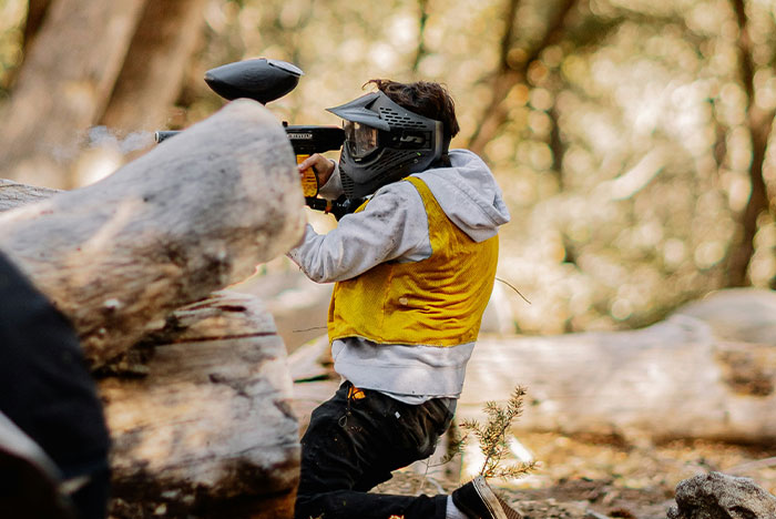Person playing paintball outdoors wearing protective gear, illustrating moments when gut instinct was 100% correct.