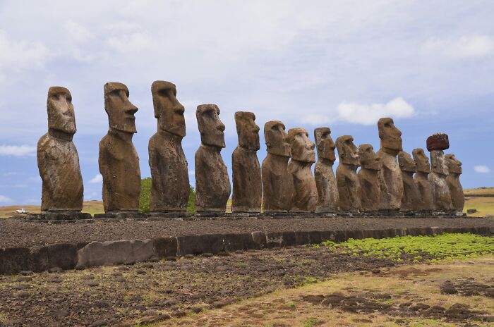 Row of spectacular sculptures on Easter Island, showcasing iconic stone statues and ancient global travel landmarks.