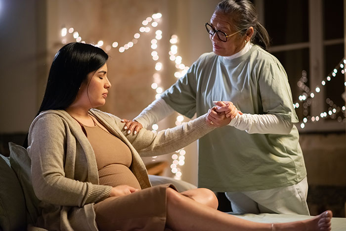 Pregnant woman receiving care from a healthcare professional highlighting mysteries about the human body still unexplained by science.