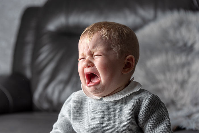 Crying baby expressing emotion illustrating mysteries about the human body that science still hasn't explained.