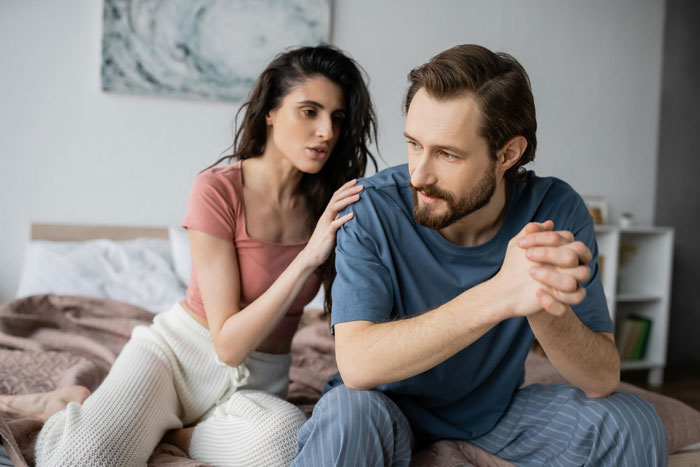 Woman&rsquo;s husband comforting her as she shows signs of obsession over pregnancy, indicating a possible life-threatening condition.