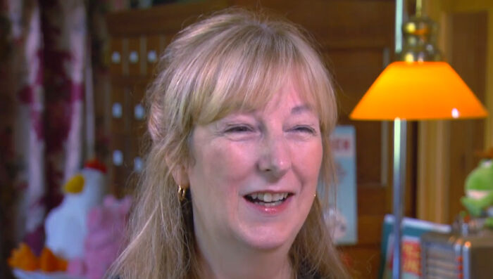 Woman smiling and sharing a story in a cozy room setting about James Franco smells and meeting their idol.