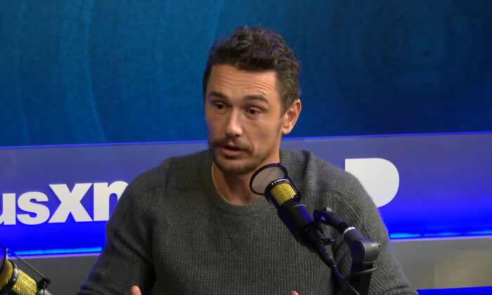 James Franco speaking into a microphone during a podcast recording in a studio with a blue background.