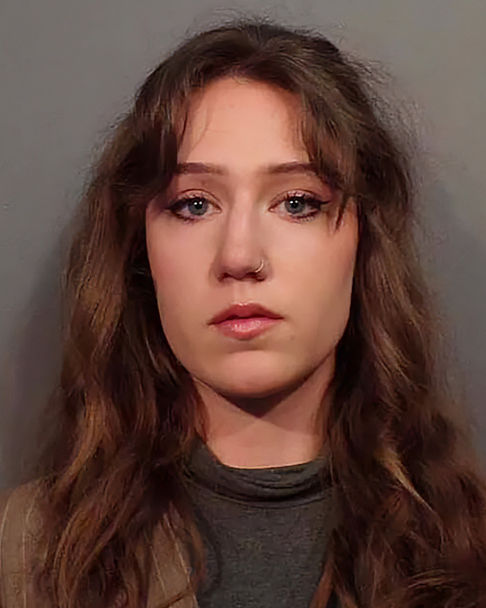 Young woman with long hair and nose ring, shown in a portrait style, linked to influencer who snatched baby wombat on camera.