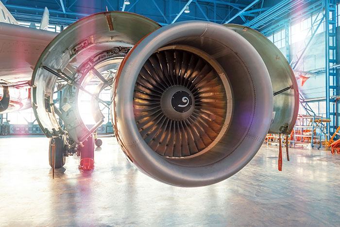 Close-up view of a plane engine inside a hangar highlighting secrets about planes and flying for passengers.