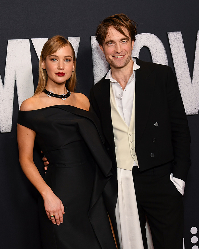 Jennifer Lawrence posing with a male co-star at a formal event, highlighting male co-stars and Jennifer Lawrence.