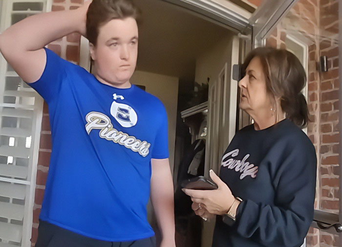 Teen and woman in tense conversation outside a brick house amid protests in Oklahoma over controversial legal case.