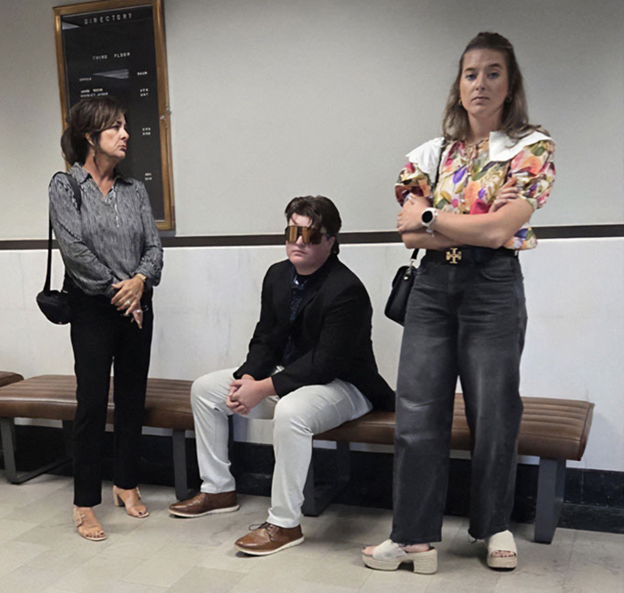 Three people inside a courthouse amid protests erupting across Oklahoma over teen case controversy.