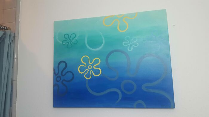 Abstract blue and green wall art with floral patterns hanging in a room, creating a calm and creative sibling gratitude vibe.