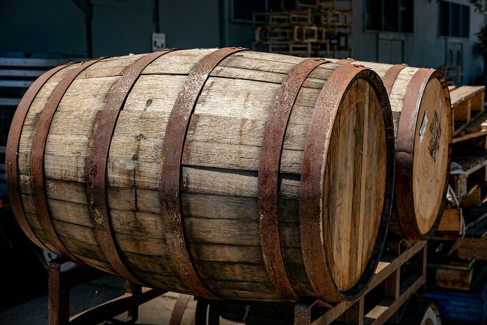 Wooden barrels with rusted metal hoops stacked, illustrating interesting laws and loopholes lawyers often discuss.