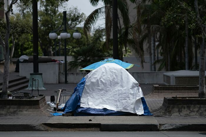 Small tent set up on urban sidewalk, illustrating some of the worst things employees have seen on Black Friday.