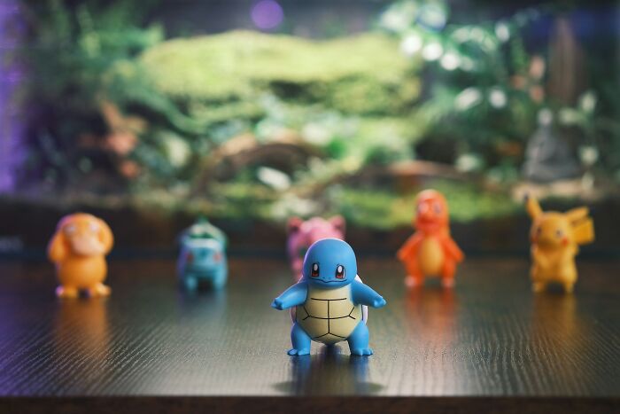 Squirtle and other Pokémon figures arranged on a wooden surface showcasing absurd but true stories that are hard to believe.
