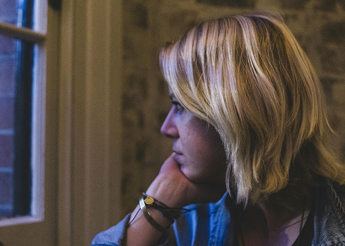 Teen girl looking thoughtfully out a window, capturing man’s reaction to teen daughter’s relationship concerns. Teen girl looking thoughtfully out a window, capturing man’s reaction to teen daughter’s relationship concerns.