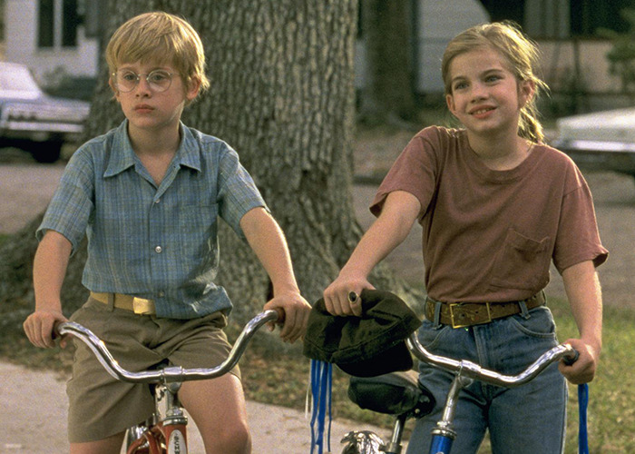 Two children on bicycles in a suburban neighborhood, referencing the infamous tragic scene from My Girl filming truth. Two children on bicycles in a suburban neighborhood, referencing the infamous tragic scene from My Girl filming truth.