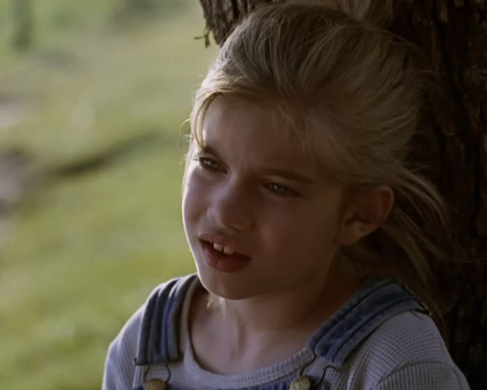 Young girl leaning against a tree in a scene from My Girl, related to Macaulay Culkin revealing filming truths. Young girl leaning against a tree in a scene from My Girl, related to Macaulay Culkin revealing filming truths.