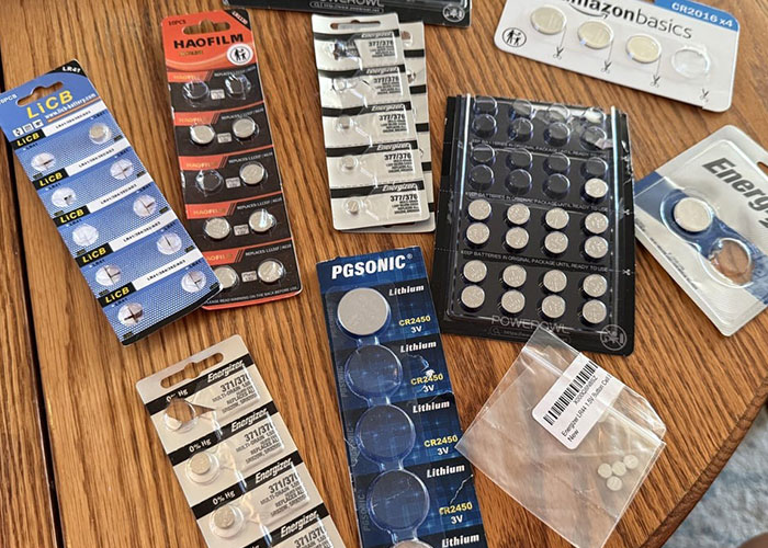 Various button batteries laid out on a table, illustrating dangerous things in everyday life for medical malpractice cases.