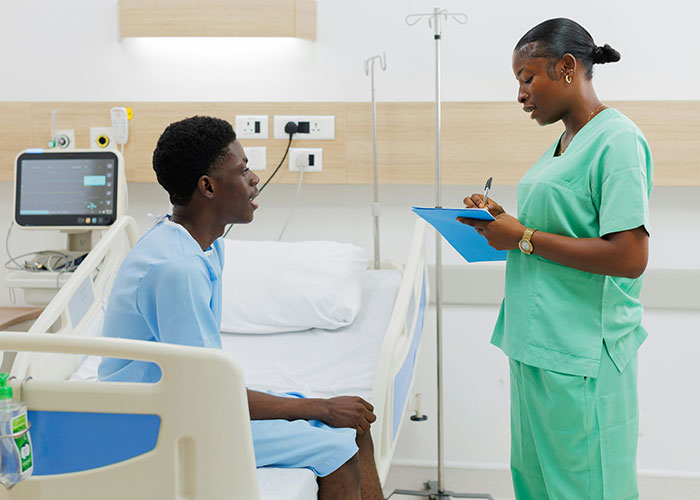 Patient speaking with a nurse in a hospital room illustrating medical malpractice lawyer insights on dangers in everyday life.
