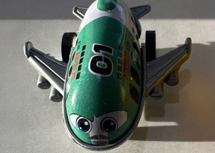 Toy airplane with a green nose viewed from above, illustrating potential dangers in everyday life by a medical malpractice lawyer.