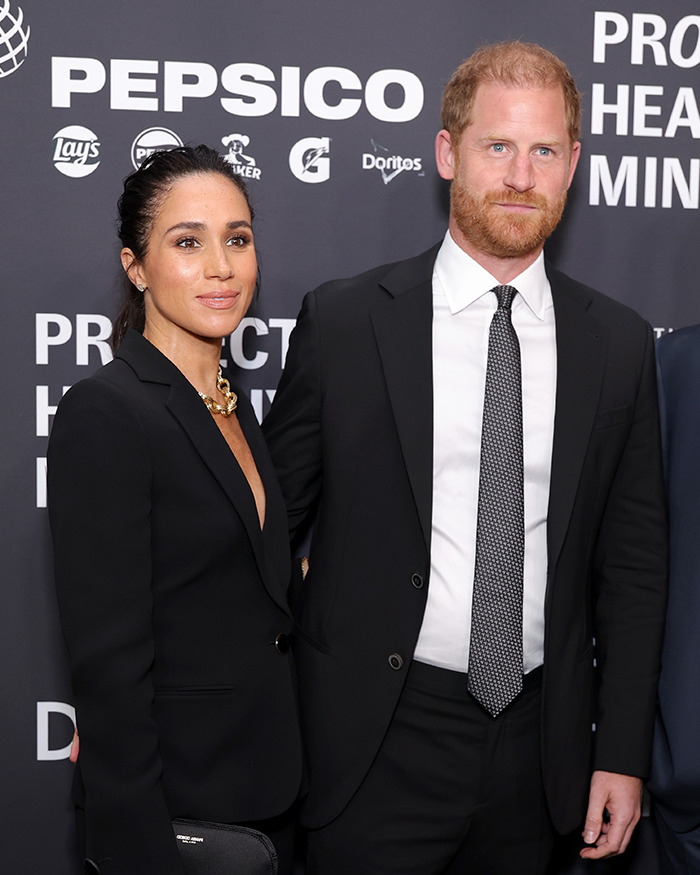 Meghan Markle and Prince Harry posing at a formal event, linked to Meghan Markle royal gesture controversy. Meghan Markle and Prince Harry posing at a formal event, linked to Meghan Markle royal gesture controversy.