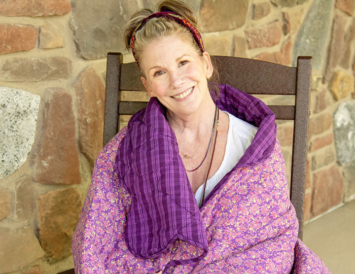 Melissa Gilbert wrapped in a purple blanket, smiling while reflecting on age gap with her on-screen husband.
