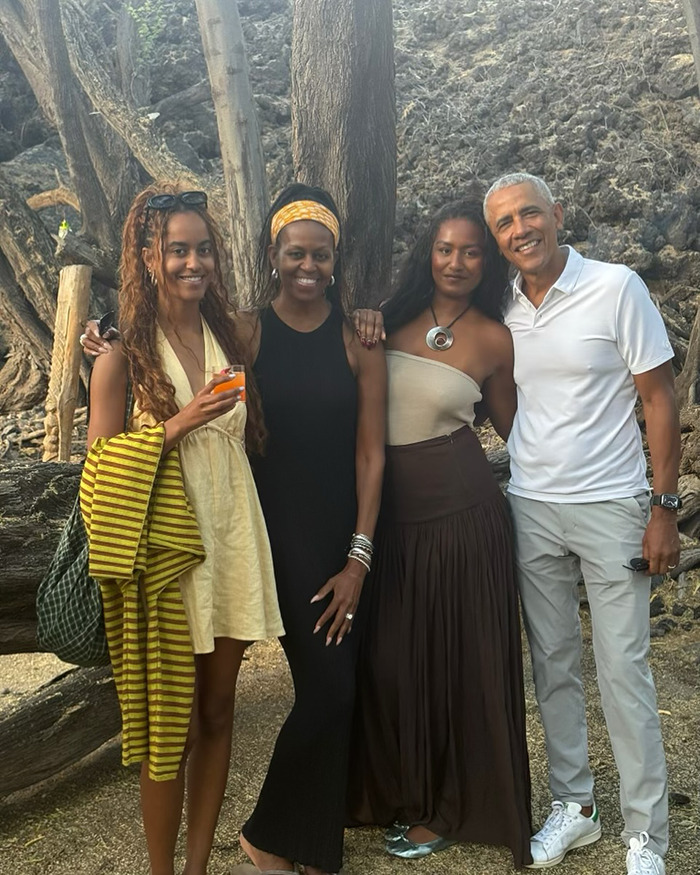 Michelle Obama with ultra-long hair in a casual outfit, smiling and posing outdoors with family in a natural setting. Michelle Obama with ultra-long hair in a casual outfit, smiling and posing outdoors with family in a natural setting.