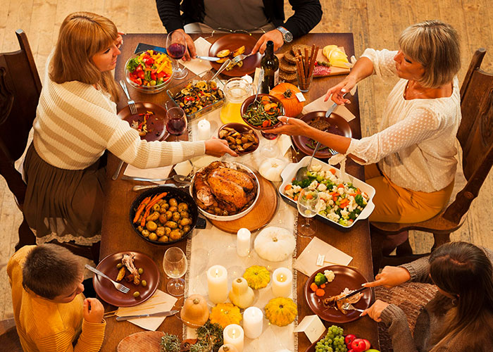 Family sharing a Thanksgiving dinner with turkey and sides after a long 12-hour shift, celebrating together around the table. Family sharing a Thanksgiving dinner with turkey and sides after a long 12-hour shift, celebrating together around the table.