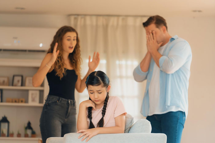 Woman deliberately excludes sick daughter-in-law from family holiday while a young girl looks upset and man covers his face in frustration. Woman deliberately excludes sick daughter-in-law from family holiday while a young girl looks upset and man covers his face in frustration.