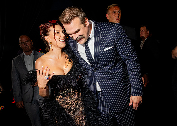 Millie Bobby Brown and David Harbour at an event, addressing rumors on Stranger Things bullying on set.