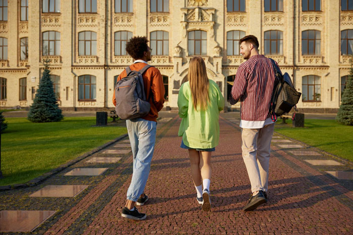 Three college students walking on campus, discussing money and family issues including mom affair and dad relationships.