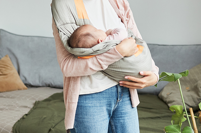 Young mother holding baby, symbolizing family conflict and a robbed future for the younger kid. Young mother holding baby, symbolizing family conflict and a robbed future for the younger kid.