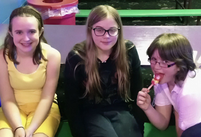 Three children sitting together, with one eating a lollipop, unrelated to Slender Man attacker captured after manhunt. Three children sitting together, with one eating a lollipop, unrelated to Slender Man attacker captured after manhunt.