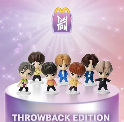 Tiny Tan McDonald's throwback edition figures displayed on a purple platform with a glowing background and McDonald’s logo above. Tiny Tan McDonald's throwback edition figures displayed on a purple platform with a glowing background and McDonald’s logo above.