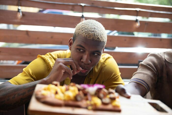 Person discovering surprising habits of partner while eating together in a casual, cozy setting after moving in.