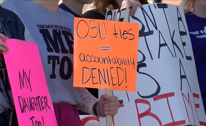 Protests erupt across Oklahoma as crowd holds signs demanding accountability for OSU amid outrage over case.