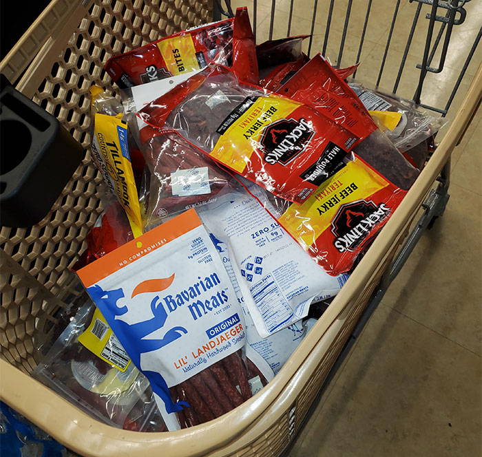 Shopping cart filled with various packaged meats illustrating a lucrative loophole exploited by shoppers.