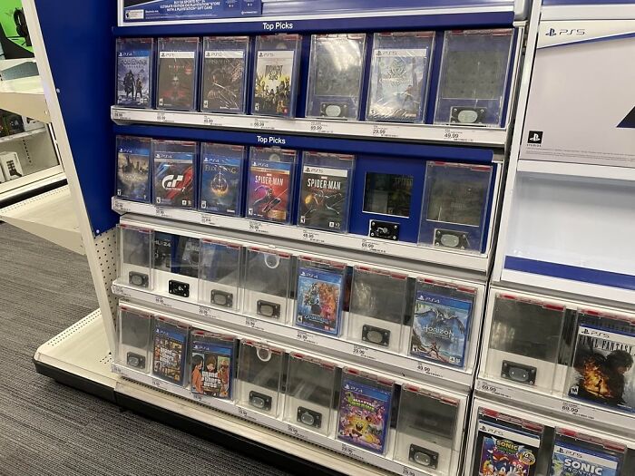 Video game display cases secured with locks in a retail store, illustrating a lucrative loophole exploited by shoppers.