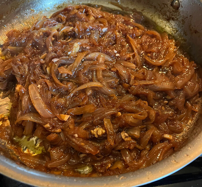 Caramelized onions cooking in a pan, demonstrating a kitchen tip to upgrade cooking skills with simple techniques.