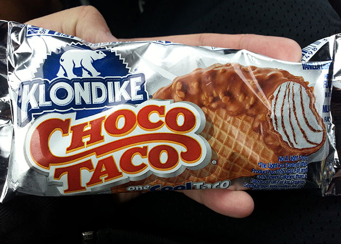 Hand holding Klondike Choco Taco ice cream, a discontinued food many people are upset about.