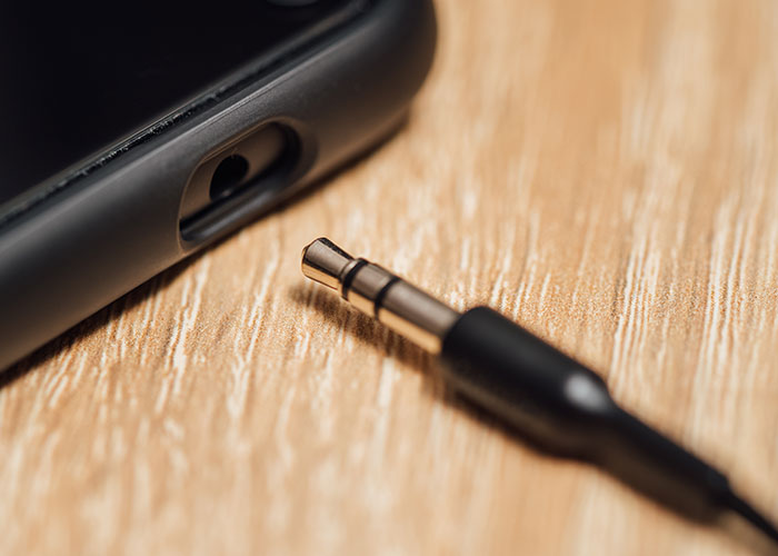Close-up of a headphone jack unplugged from a device, symbolizing things and foods that were discontinued.