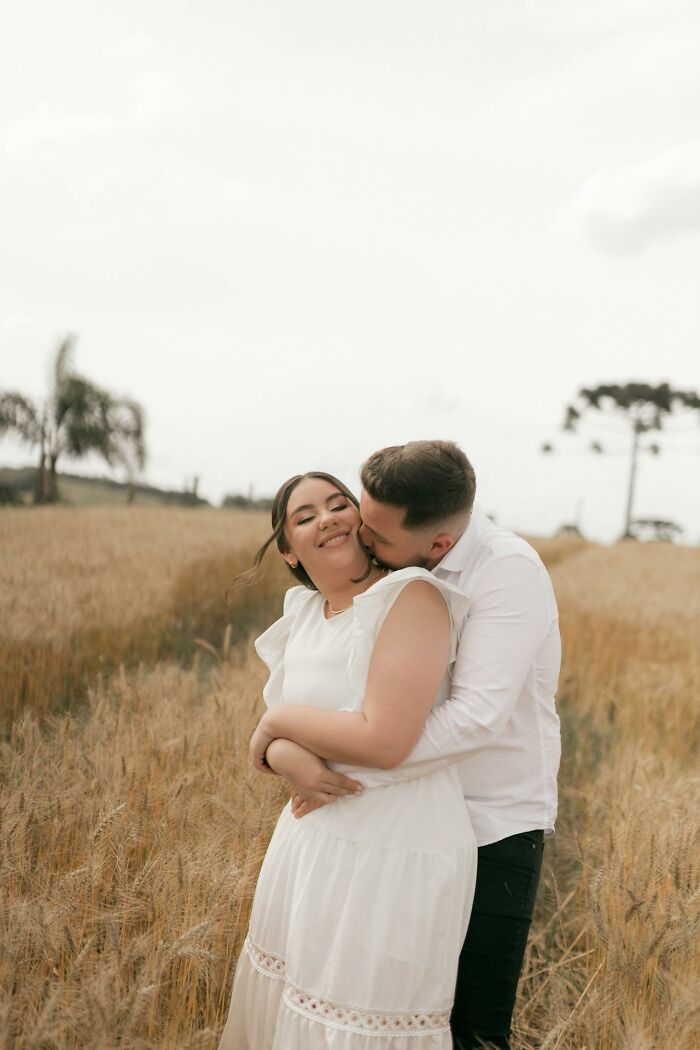 Couple embracing in a wheat field, illustrating love and connection in marriage reality and harsh truths.