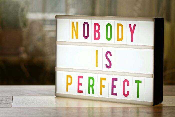 Lightbox sign displaying the phrase nobody is perfect with colorful letters, highlighting toxic relationship traits concept.