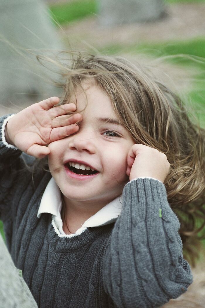 Happy child playing outdoors, capturing funny and serious moments parents realize they are raising monsters.