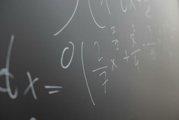 Close-up of complex math equations on a chalkboard representing challenges of all 12 grades of math quiz.