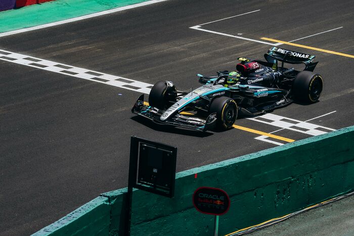 Formula 1 race car speeding on track with Nepo Babies insider experiences concept implied in sports context.