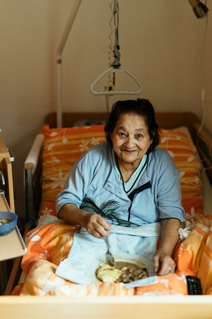 Elderly patient eating in bed in a psych ward, highlighting the intense care nurses provide in mental health settings.