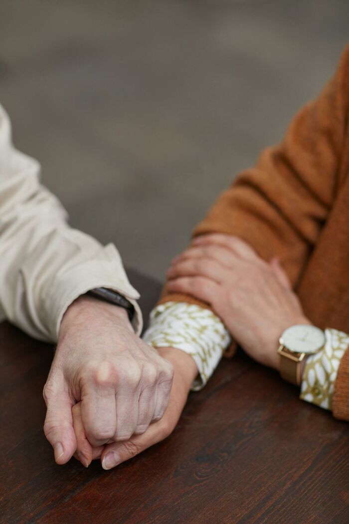 Close-up of a couple holding hands, symbolizing marriage and the harsh truths experienced in relationships.