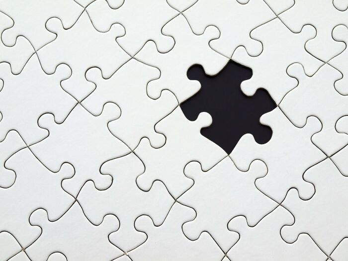 Close-up of a white jigsaw puzzle with one missing piece, symbolizing general knowledge brain teasers. Close-up of a white jigsaw puzzle with one missing piece, symbolizing general knowledge brain teasers.