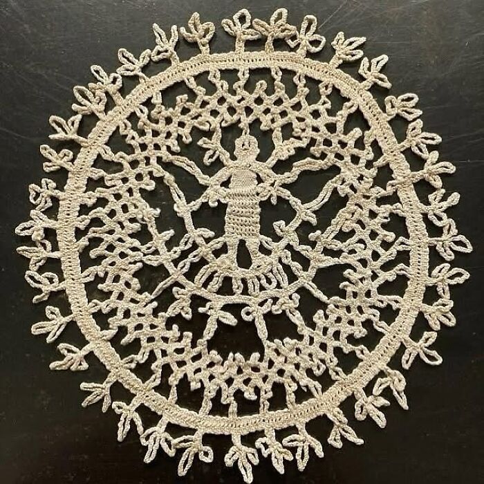 Intricately handwoven very old object displaying ancestral craftsmanship and storytelling through detailed lacework design.